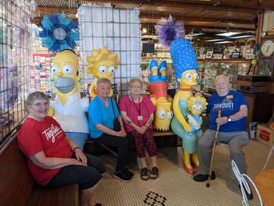 Residents posing with cartoon figures in an activity area