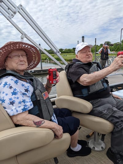 Two residents enjoying a boat ride outdoors