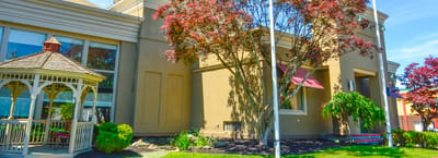 Exterior view of the facility with landscaping and a gazebo