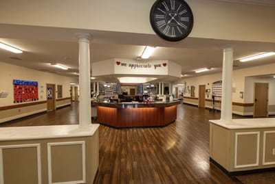 Common area with a reception desk and clock