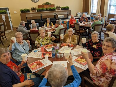 Residents enjoying a lively group activity in a dining area