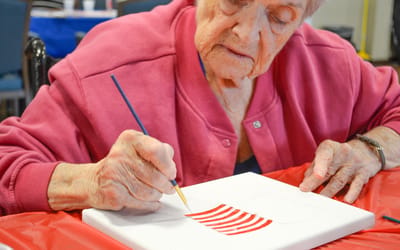Resident painting during an activity session