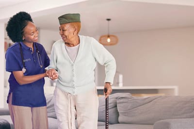 Caregiver assisting a resident in a living space.