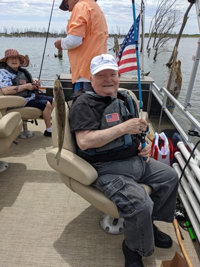 Residents fishing on a boat, enjoying a sunny day