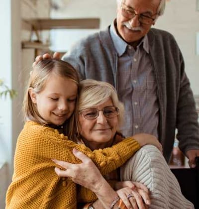 A grandparent embracing a child with joy