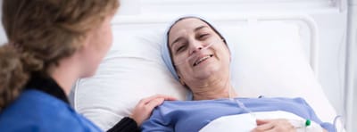 Patient smiling with caregiver in a hospital room