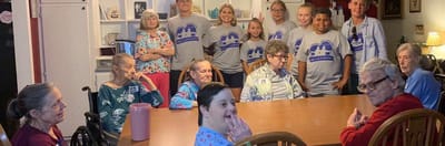 Residents and staff engaged in a group setting.