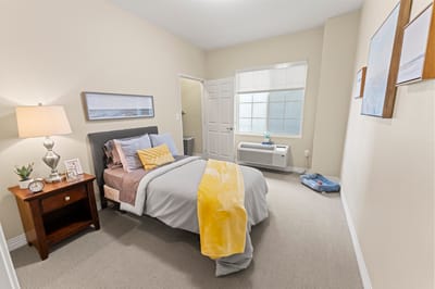 Cozy private resident room with bed and decor
