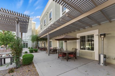 Patio area with outdoor seating and a shade structure.