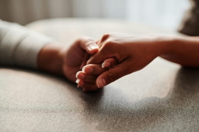 Two hands holding each other.