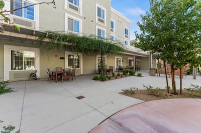 Outdoor patio area with seating and landscaped plants.