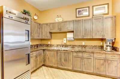 Modern kitchen with brown cabinets and appliances.