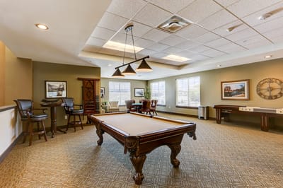 Common area with a pool table and seating.
