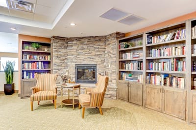Cozy reading nook with bookshelves and armchairs