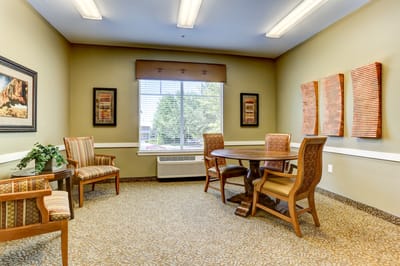 Cozy interior common area with seating and a table.