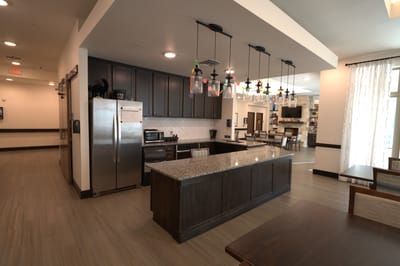 Modern kitchen area with cabinets and appliances