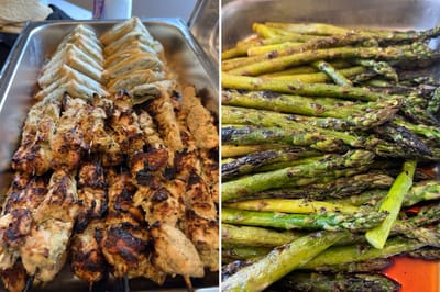 Grilled chicken skewers and asparagus on a tray