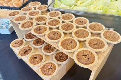 Desserts displayed on a tiered wooden stand.