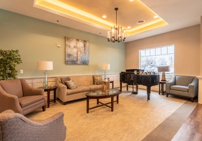 Comfortable lounge area with piano and seating.