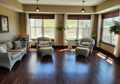 Cozy common area with armchairs and windows.