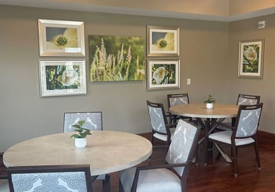 Common area with tables and art on the walls