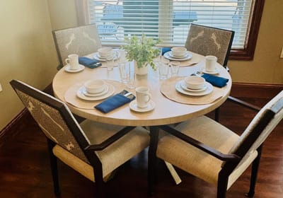 Dining table set with dishes and glassware.