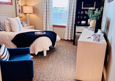 Cozy bedroom with a bed and chair.