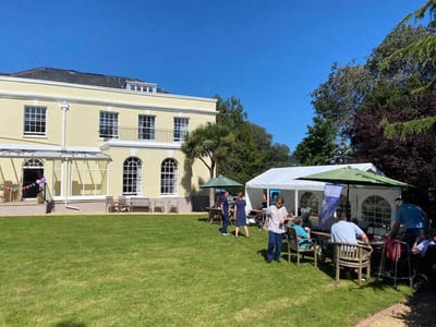 Outdoor view of residents and staff in a garden area