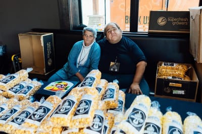 Residents enjoying popcorn at a facility event
