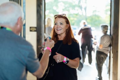 Resident smiling and interacting with staff in a common area
