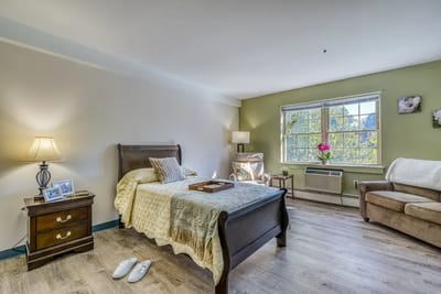 Cozy resident room with bed and light