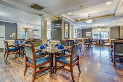 Bright dining area with tables and chairs set for a meal