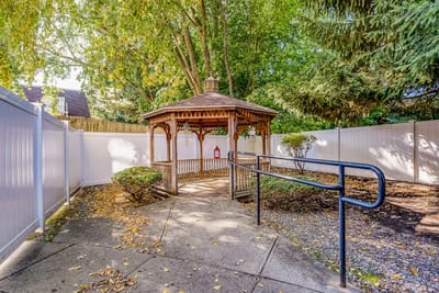 Outdoor gazebo surrounded by greenery