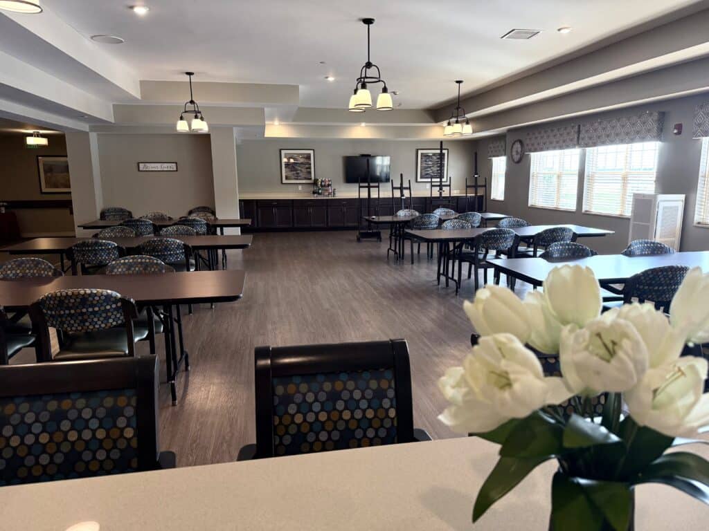 Bright common area with tables and chairs.