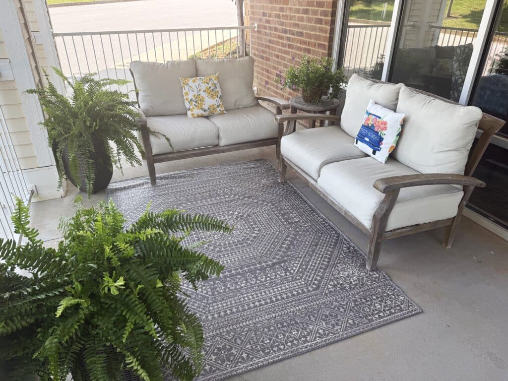 Cozy outdoor seating area with plants and cushions