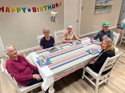 Residents celebrating a birthday in a common area