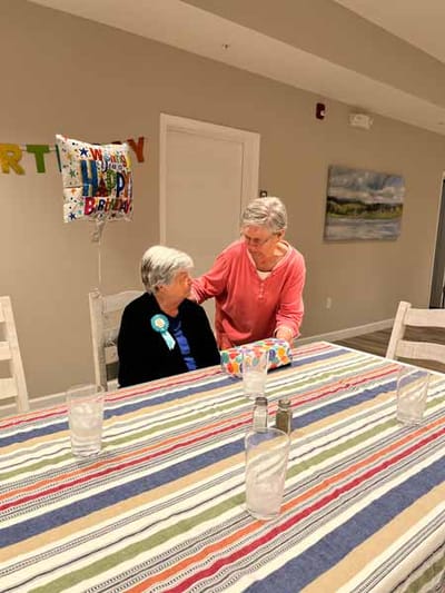 Two residents celebrating a birthday in a common area