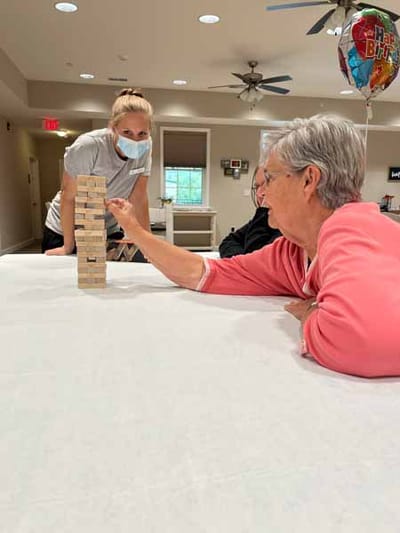 Residents playing Jenga in a common area