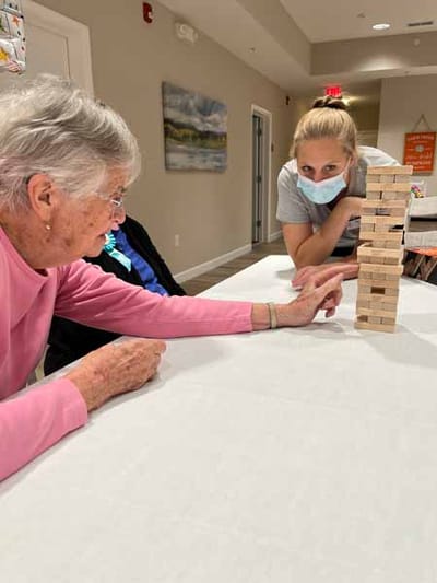 Residents engaging in a game of Jenga in the activity room