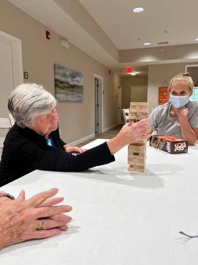 Residents enjoying a game of Jenga in an activity room