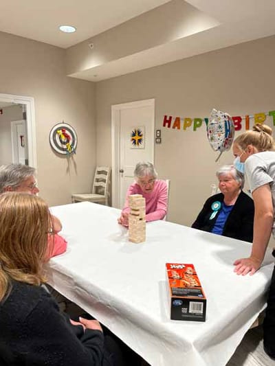 Residents enjoying a game of Jenga in a common area