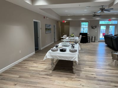 Interior common area with tables and chairs arranged.
