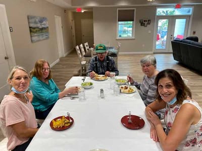 Residents enjoying a meal together in the dining room
