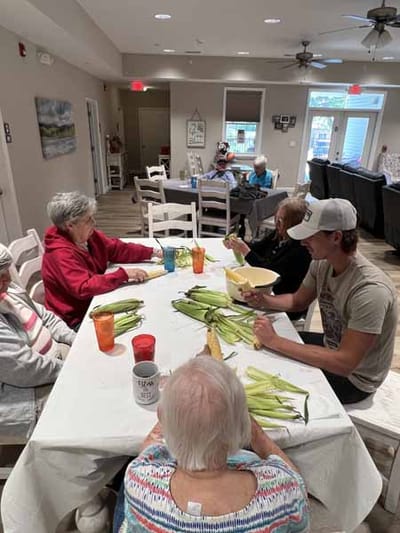 Residents engaged in an activity at a dining table