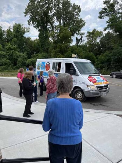 Residents gathered outside for an ice cream truck visit