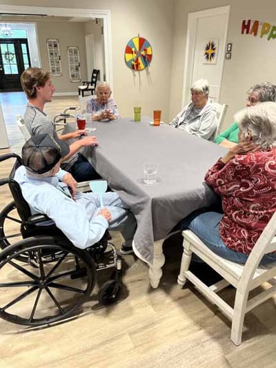 Residents engaging in a group activity around a table