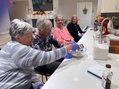 Residents participating in a baking activity in the kitchen