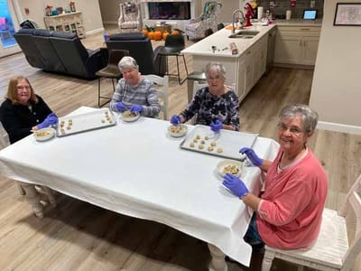 Residents participating in a cooking activity at a shared table