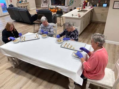 Residents participating in an activity at a communal table