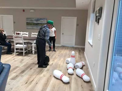 Senior resident bowling in a common area